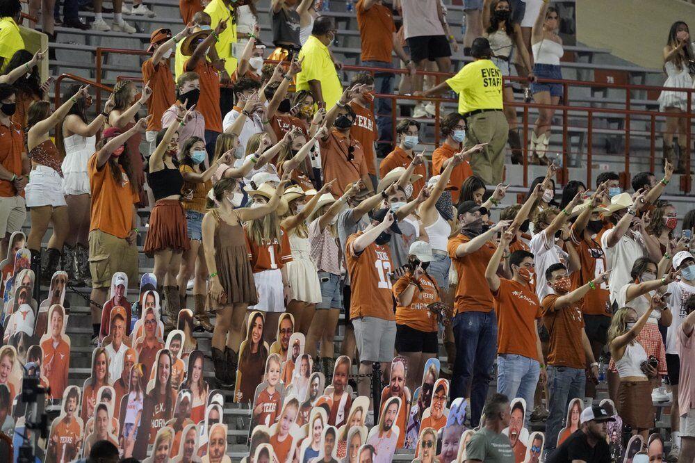 FILE - In this Saturday, Sept. 12, 2020, file photo, fans join in singing "The Eyes of Texas" after Texas defeated UTEP 59-3 in an NCAA college football game in Austin, Texas. The University of Texas' long-awaited report on the history of the school song &#8220;The Eyes of Texas&#8221; found it had &#8220;no racist intent,&#8221; but the school will not require athletes and band members to participate in singing or playing it at games and campus events. The song had erupted in controversy in 2020 after some members of the football team demanded the school stop playing it because of racist elements in the song&#8217;s past. (AP Photo/Chuck Burton, File)