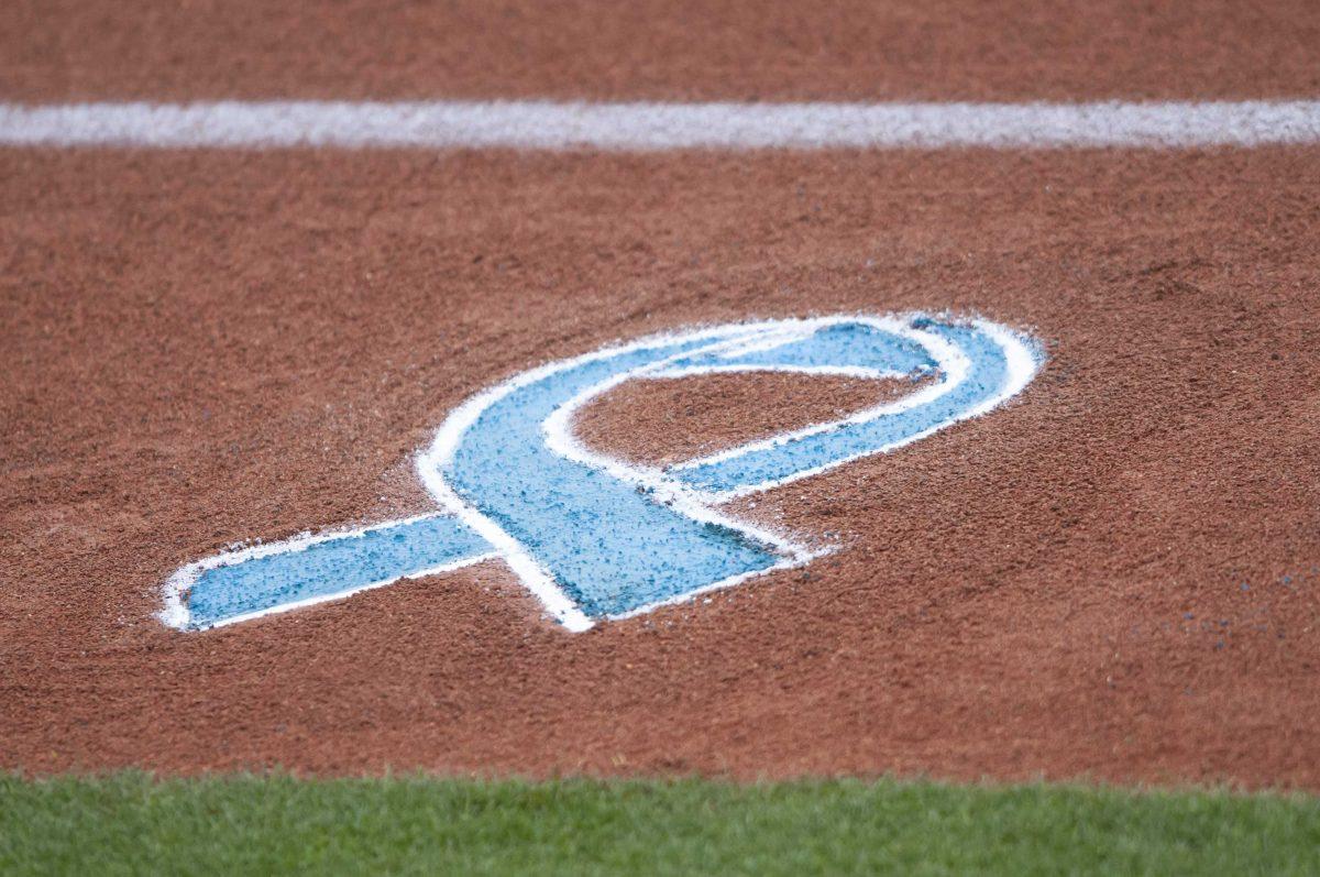 A chalk drawing of a teal ribbon is drawn on the field Saturday, March 20, 2021 as the SEC softball community honors Mississippi State's Alex Wilcox at Tiger Park on Skip Bertman Drive in Baton Rouge.