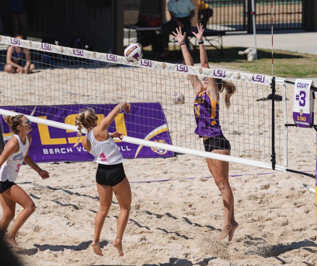 LSU beach volleyball sophomore Grace Seits (11) leaps to block the ball on Mar. 6, 2021 during LSU&#8217;s win over Florida Atlantic University at the beach volleyball stadium on Cypress Dr.