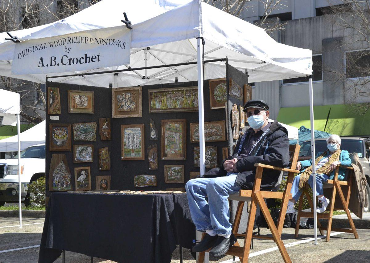 A.B Crochet sits at his stand Original Wood Relief Paintings Saturday, Mar. 6, 2021 at the Red Stick Farmers Market on 501 Main St in Baton Rouge.