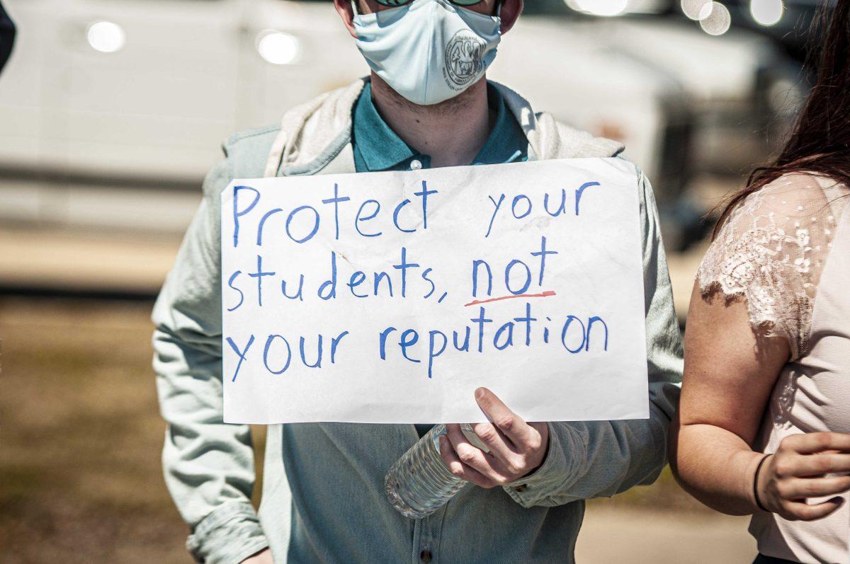 Agriculture business senior Daniel Garbr holds a sign while blockading exit on Monday, March 8, 2021 during the Tigers Against Sexual Assault sit-in at the Football Operations Center on Skip Bertman Drive.