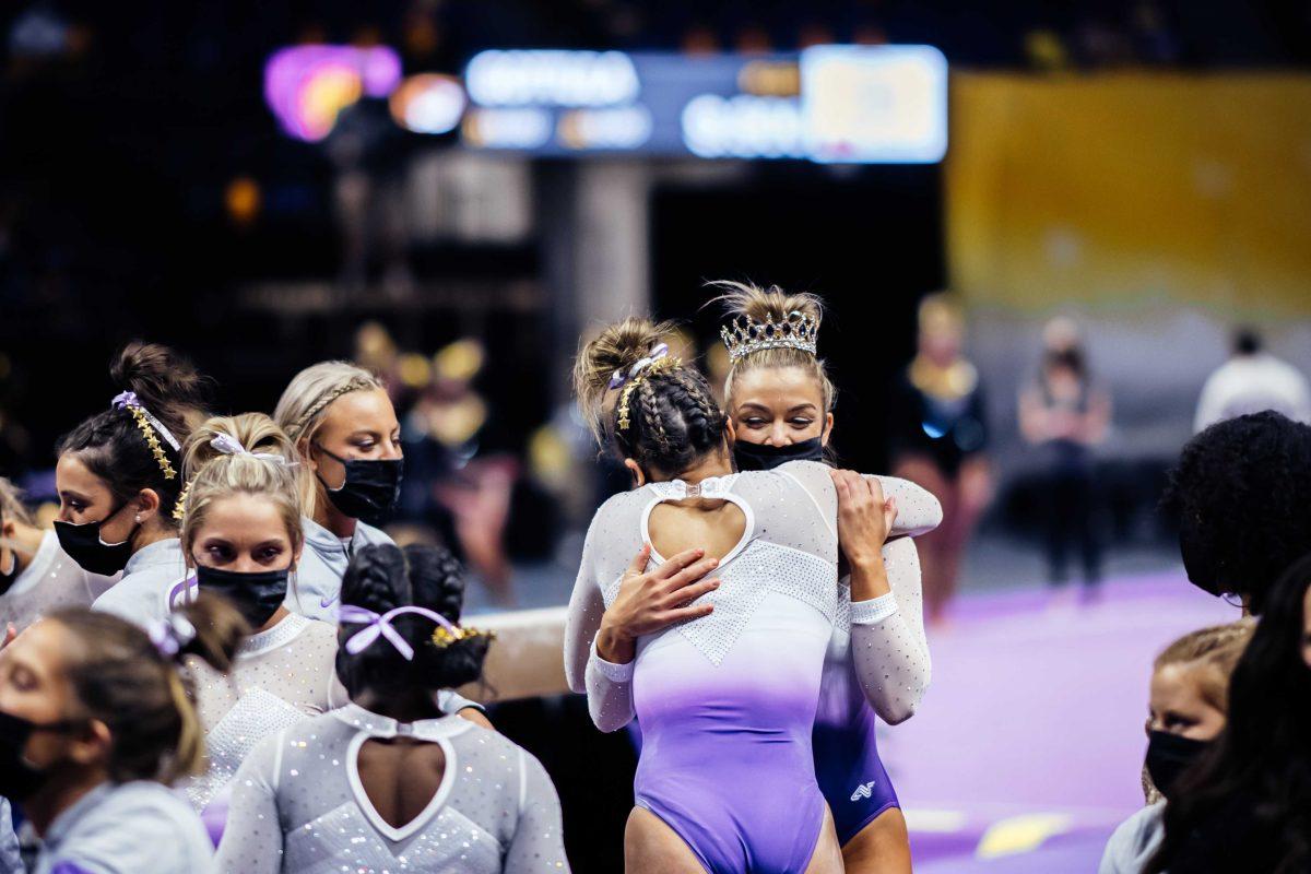 <p>LSU gymnastics senior bars, beam and floor Bridget Dean hugs freshman all-around Haleigh Bryant after her beam routine Friday, March 3, 2021 during LSU's 197.875-196.175 win over Missouri in the Pete Maravich Assembly Center on N. Stadium Drive in Baton Rouge, La.</p>