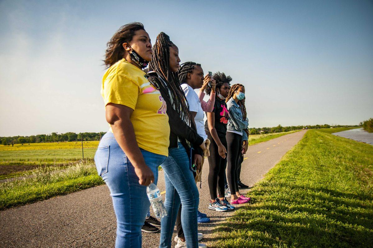 Search party volunteers survey the area on Sunday, April 11, 2021 at the Mississippi River bike trial on Skip Bertman Drive.