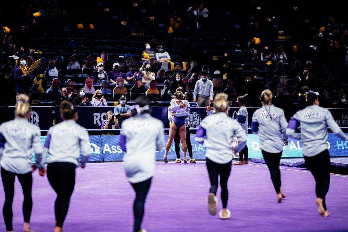 LSU gymnastics team rushes to hug senior floor Olivia Gunter after her last floor routine Friday, March 3, 2021 during LSU's 197.875-196.175 win over Missouri in the Pete Maravich Assembly Center on N. Stadium Drive in Baton Rouge, La.