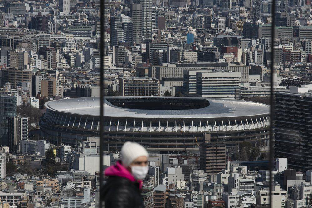 FILE - In this March 3, 2020, file photo, the New National Stadium, a venue for the opening and closing ceremonies at the Tokyo 2020 Olympics, is seen from Shibuya Sky observation deck in Tokyo. Organizers and the International Olympic Committee are pushing on despite COVID-19 risks, myriad scandals, and overwhelming public opposition in Japan to holding the games. (AP Photo/Jae C. Hong, File)