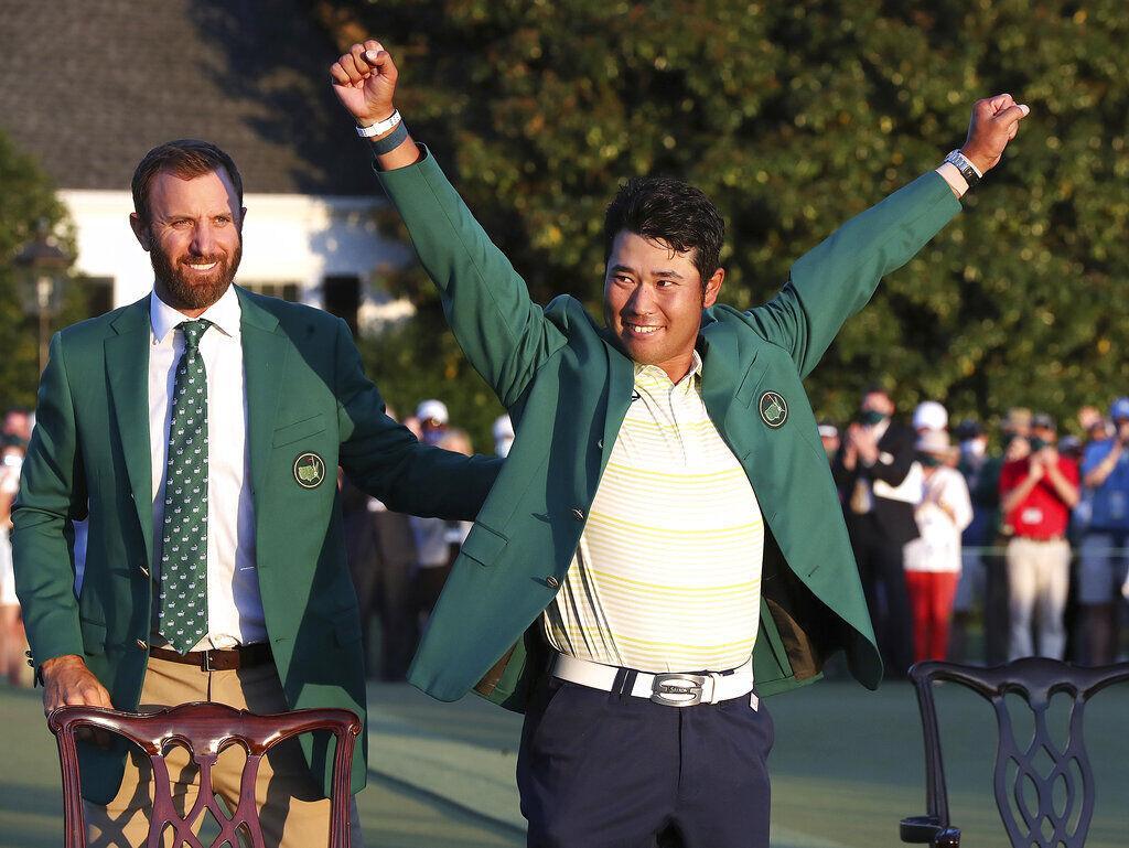 Hideki Matsuyama, of Japan, celebrates while wearing the champion's green jacket as Dustin Johnson looks on after winning the Masters golf tournament on Sunday, April 11, 2021, in Augusta, Ga.&#160;