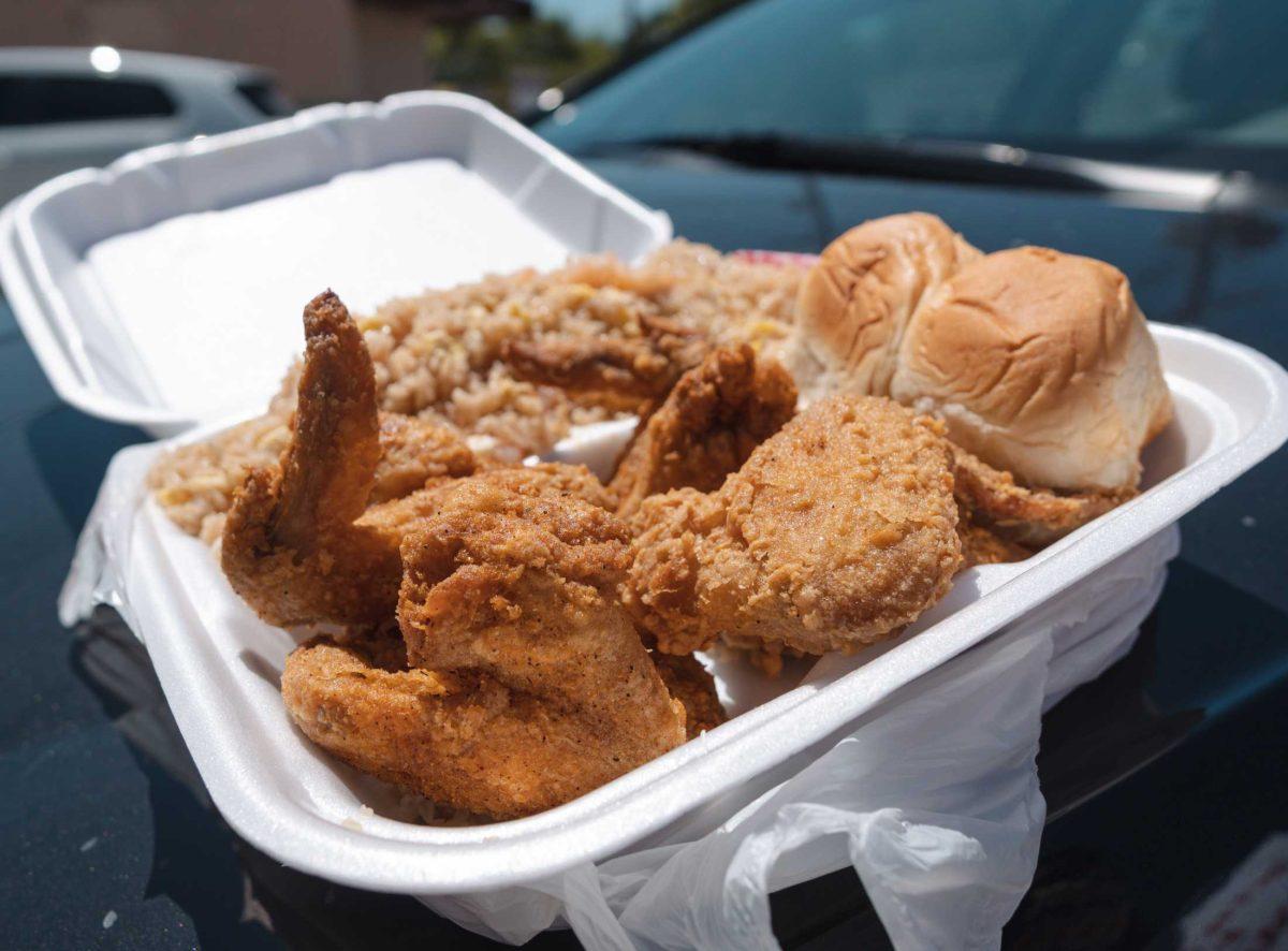 A six-piece wing with shrimp fried rice and rolls sits in its container on April 8, 2021 outside of Triplet&#8217;s Blue Store II on Highland Road.