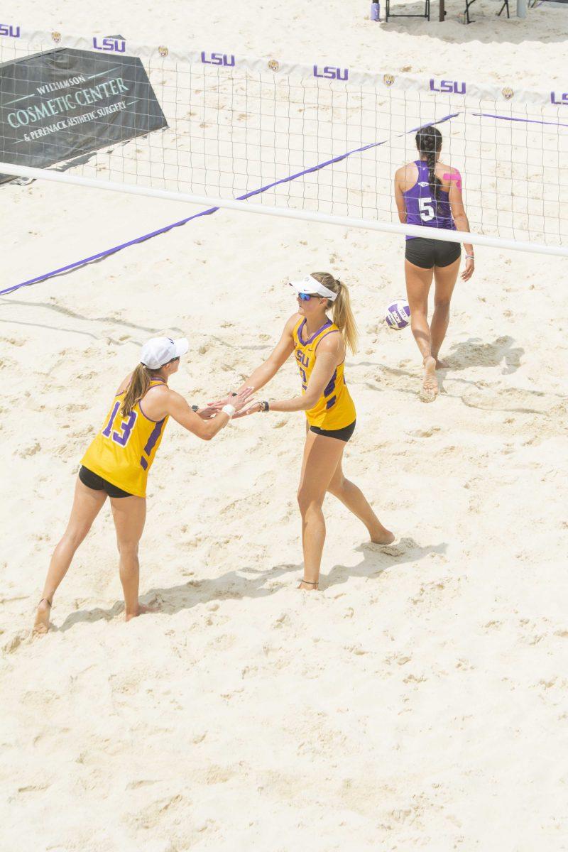 LSU beach volleyball senior Kristen Nuss (13) and senior Taryn Kloth (12) celebrate a point on April 9, 2021 during LSU&#8217;s win over Spring Hill College at the beach volleyball stadium on Cypress Dr.