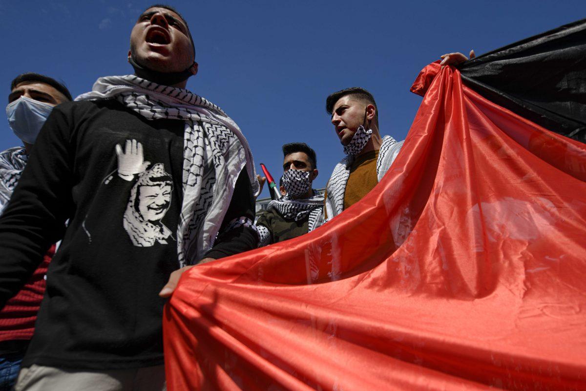 Members of the Arab community, shout slogans during a protest joined by more than one hundred people in Bucharest, Romania, Saturday, May 15, 2021, against Israel's offensive in Gaza. Anger against the Israeli offensive in Gaza drew protests elsewhere in Europe on Saturday, with thousands of people marching to protest Israel's attacks which included an Israeli airstrike that blew up the 12-story building in Gaza that housed media outlets, including The Associated Press. (AP Photo/Andreea Alexandru)