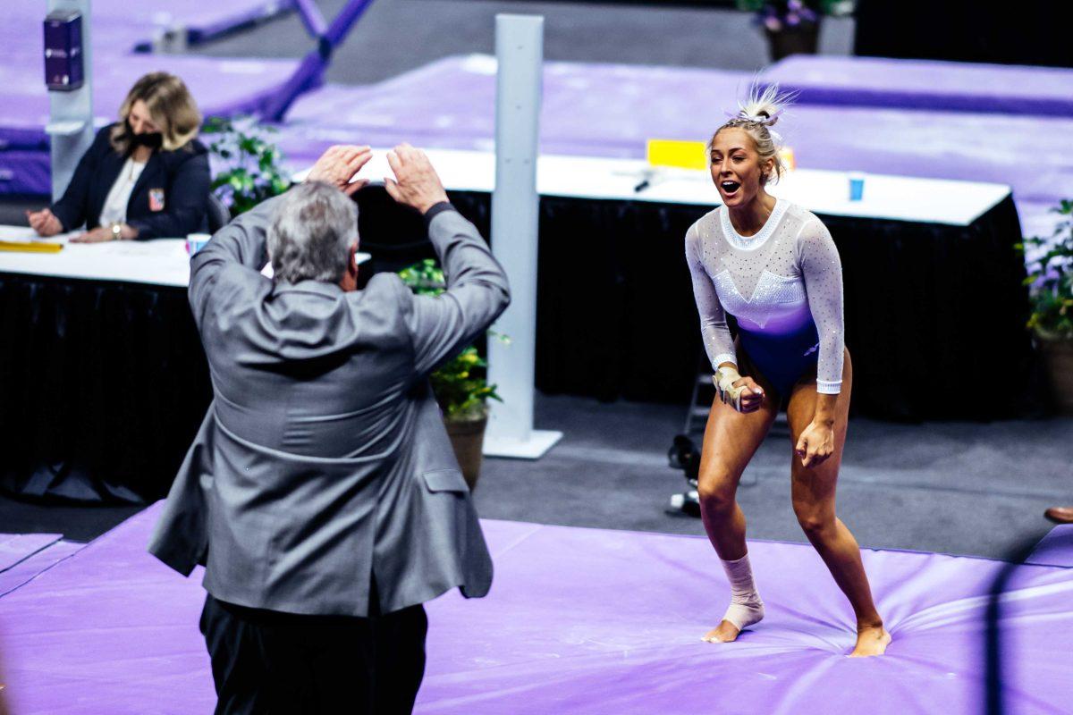 <p>LSU gymnastics senior vault, uneven bars, and balance beam Sami Durante cheers with assistant coach Bob Moore after her vault routine Friday, March 3, 2021 during her senior night before LSU's 197.875-196.175 win over Missouri in the Pete Maravich Assembly Center on N. Stadium Drive in Baton Rouge, La.</p>