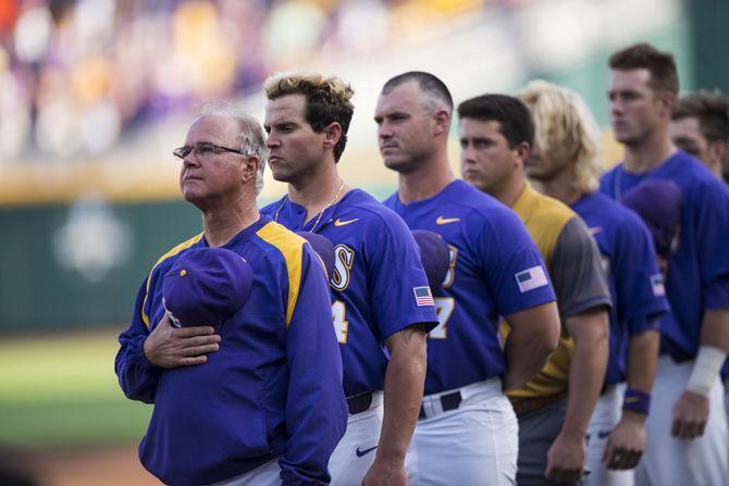 LSU head baseball coach Paul Mainieri and the LSU Tigers remove their hats for the National Anthem during LSU's 6-1 loss to Florida in game two of the College World Series on Tuesday June 27, 2017, at the TD Ameritrade Center in Omaha, Nebraska.