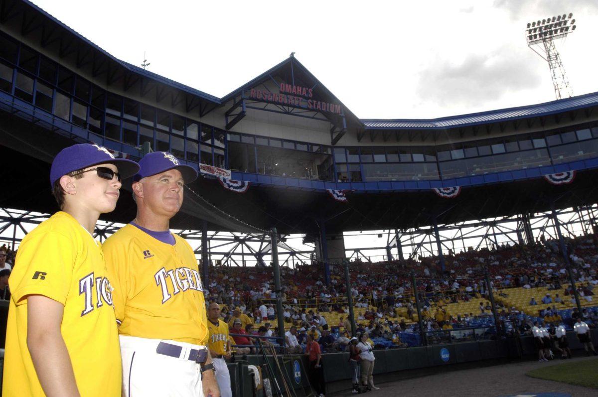 LSU head baseball coach Paul Mainieri and his 17-year-old son, Tommy, look upon the field at Johnny Rosenblatt Stadium in Omaha, Neb., where the College World Series is held every summer.