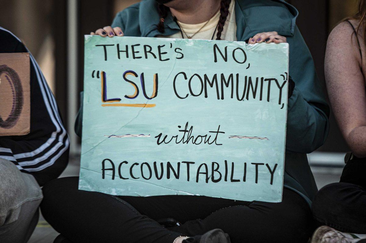 Students display signs on Monday, March 8, 2021 during the Tigers Against Sexual Assault sit-in at the Football Operations Center on Skip Bertman Drive.