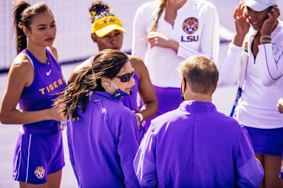 LSU women's tennis co-head coach Julia Sell pulls her mask down to talk to co-head coach Michael Sell Sunday, Jan. 31, 2021 during LSU's 4-0 win over Rice at the LSU Tennis Complex on Gourrier Avenue in Baton Rouge, La.