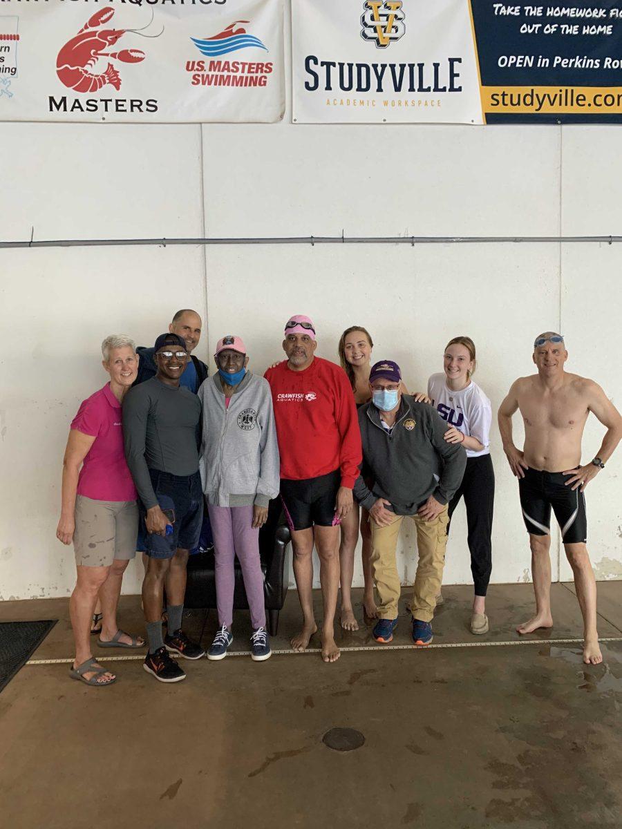 Herman Kelly, his wife and participants pose at "Swim for Life"