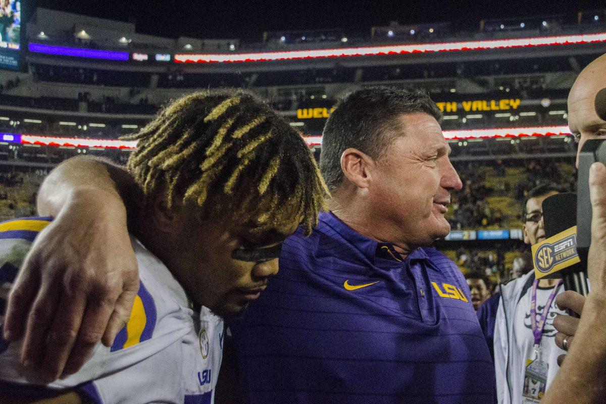 Coach Ed Orgeron speaks to cameras with LSU junior running back Derrius Guice (5) after the Tigers' 45-21 lead against Texas A&amp;M on Saturday, Nov. 25, 2017, in Tiger Stadium.