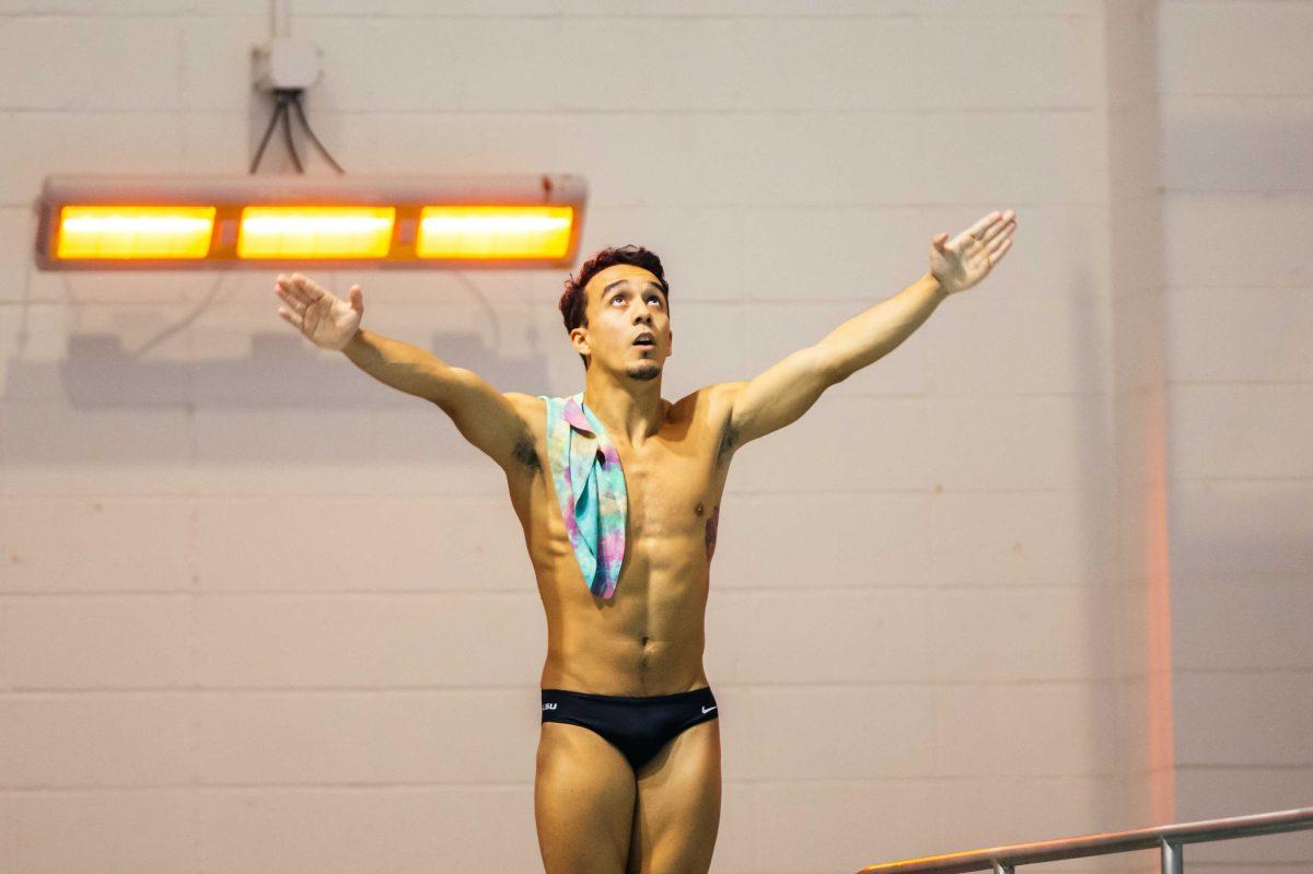 LSU diving senior Juan Celaya-Hernandez throws his hands up and takes a deep breath Friday, Nov. 6 during the LSU swimming and diving vs. Alabama meet where men lost 194-84 and women lost 183-117 in the LSU Natatorium on W Chimes street in Baton Rouge, La.