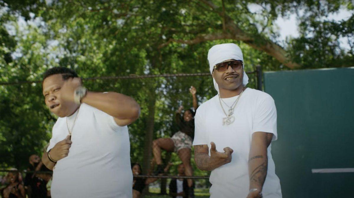 Juvenile (right) and Mannie Fresh (left) dance in the music video of their parody song, "Vax That Thang Up."