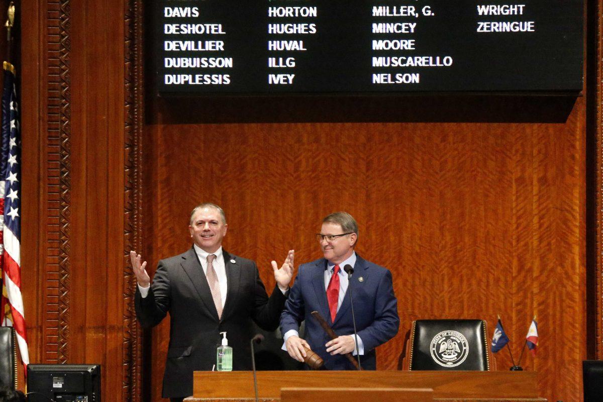 FILE - In this March 9, 2020 file photo, Louisiana House Speaker Clay Schexnayder, R-Gonzalez, left, and Senate President Page Cortez, R-Lafayette, react after Cortez broke Schexnayder's gavel for the opening of the 2020 general legislative session in Baton Rouge, La. Louisiana lawmakers will hold their first veto session under the state's nearly 50-year-old constitution. The session will open Tuesday, July 20, 2021, and last up to five days. (AP Photo/Gerald Herbert, File)