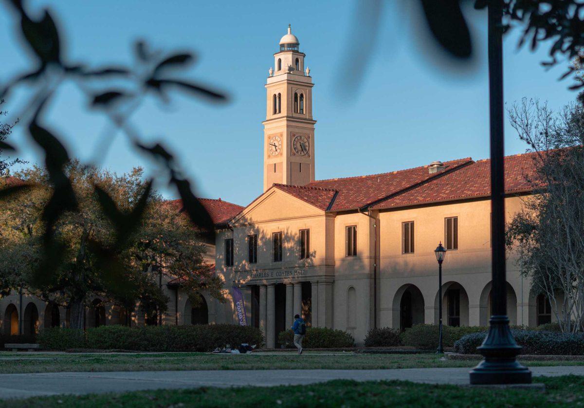 An LSU student walks through in front of Coates Hall on Mar. 3, 2021 in LSU&#8217;s Quad.