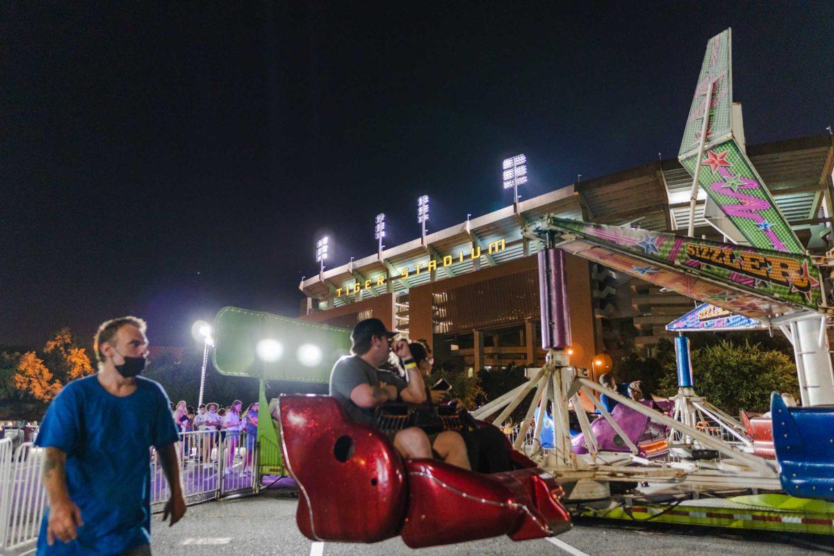 Tiger Stadium stands on Aug. 21, 2021, in the background of the LSU Welcome Week Carnival in Lot 401 on South Stadium Drive on LSU&#8217;s campus.