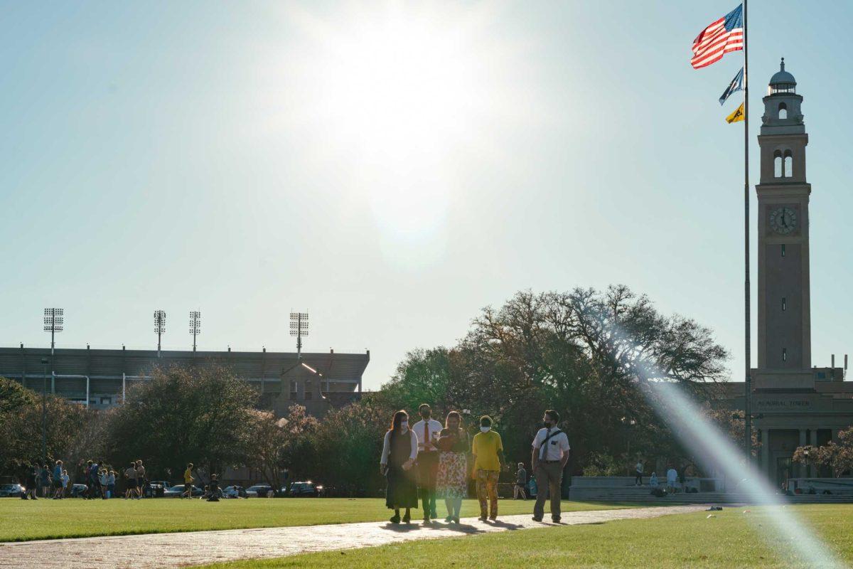 A group of students walks through the Parade Ground on Mar. 3, 2021 toward the LSU Law Center.