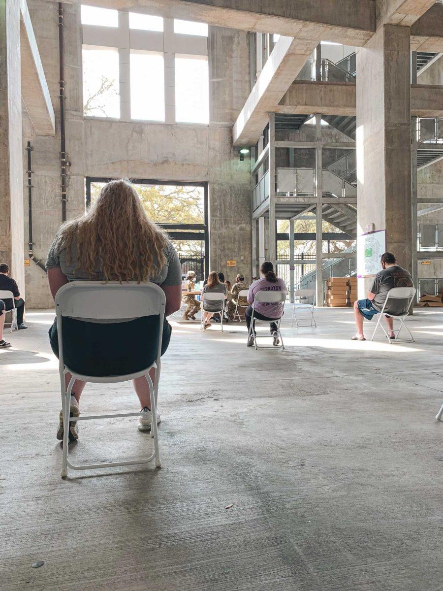 Several people sit in the observation area on Mar. 14, 2021 after receiving their COVID-19 vaccine at Tiger Stadium.