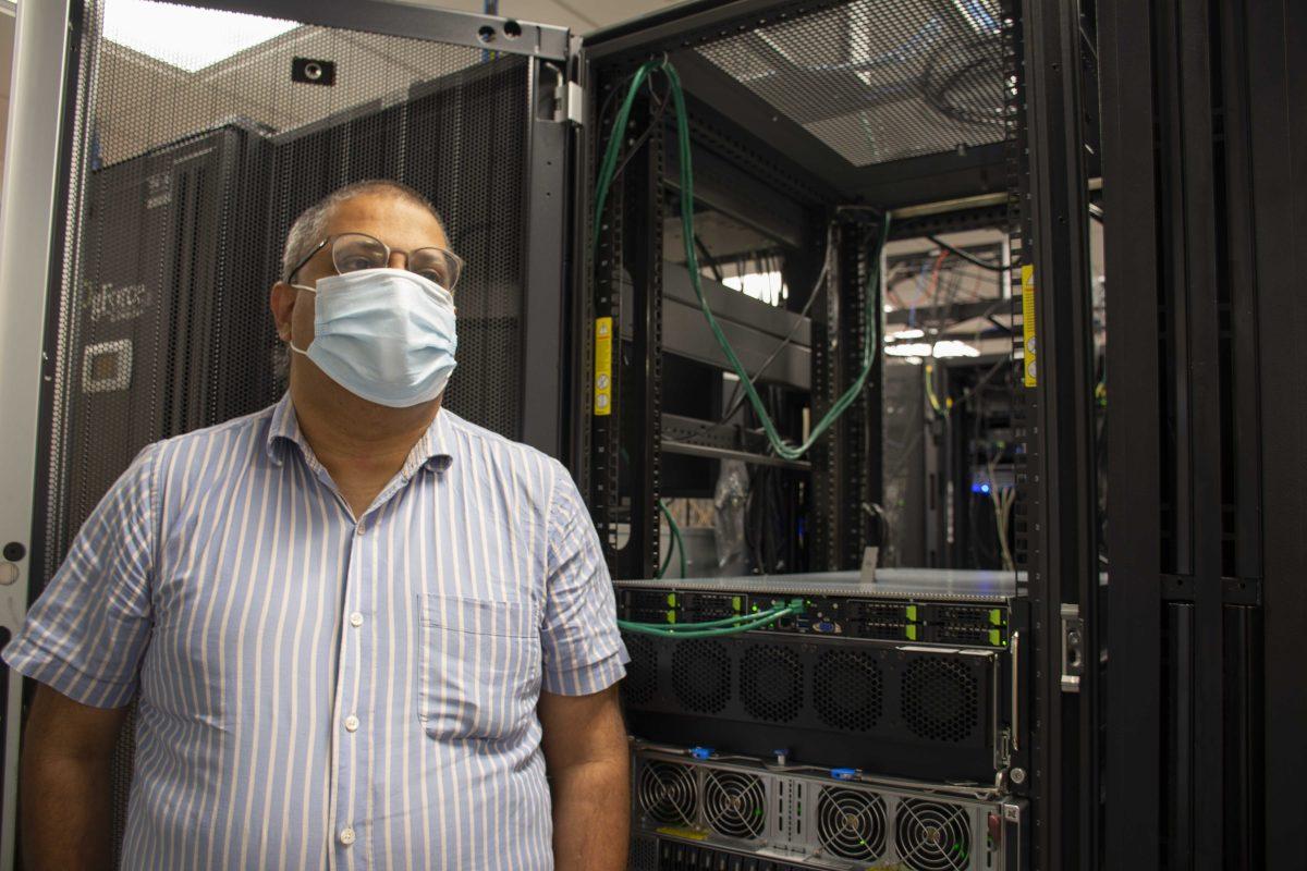 LSU computer science professor Supratik Mukhopadhyay stands next to DGX A 100 and DGX 1 machines Monday, Aug. 23, 2021, at Patrick F. Taylor Hall.