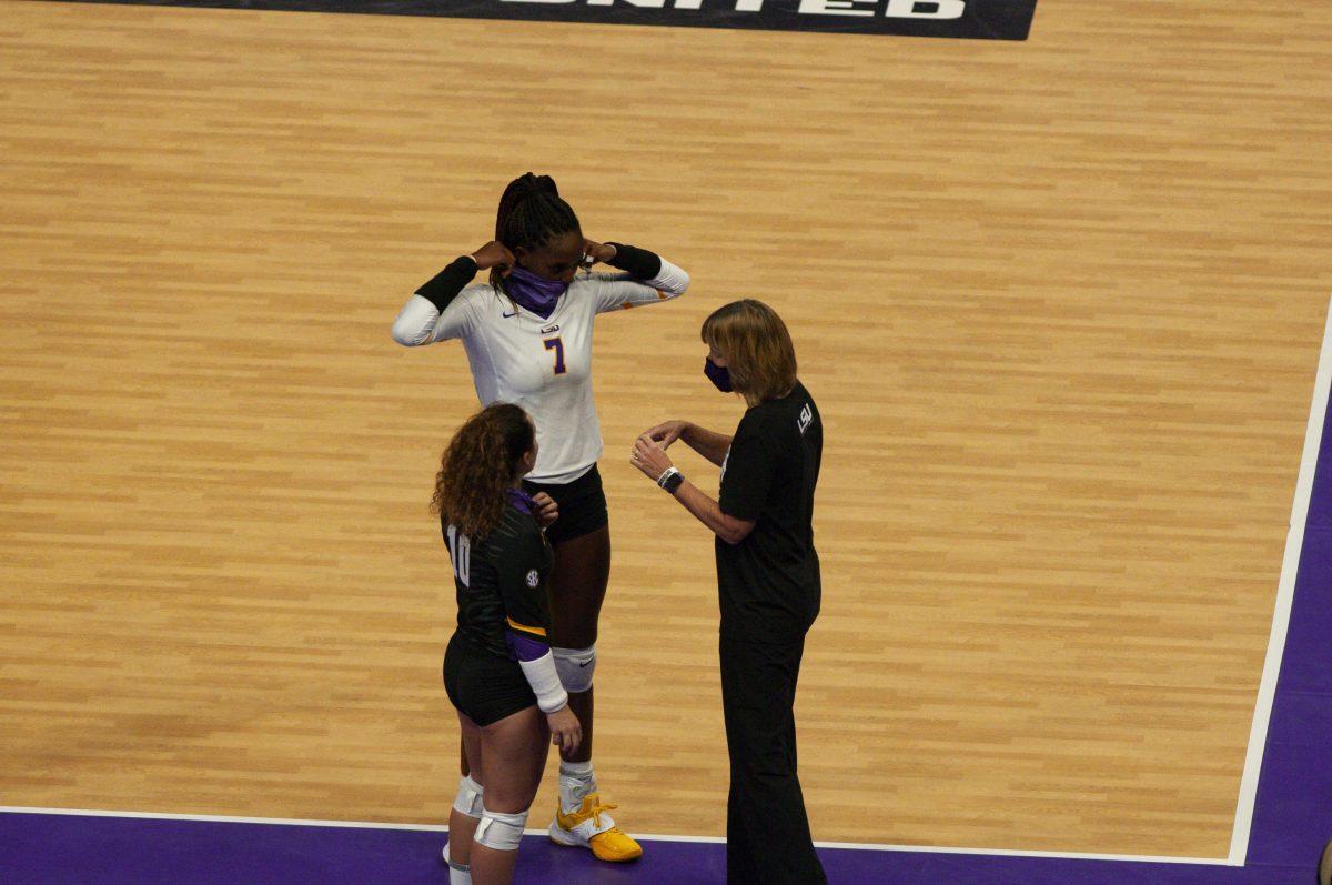 LSU volleyball players sophomore defensive specialist Jill Bohnet (10) and senior right side hitter Taylor Bannister (7) talk strategy with Head Coach Fran Flory on Thursday, Oct. 22, 2020 during LSU volleyball's 3-1 win against Mississippi State at the Pete Maravich Assembly Center on N Stadium Center Drive.