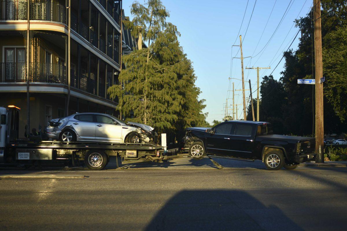 A car wrecker loads two cars Thursday, Sept. 9, 2021, on the corner of Nicholson Drive and W. Chimes Street in Baton Rouge, La.