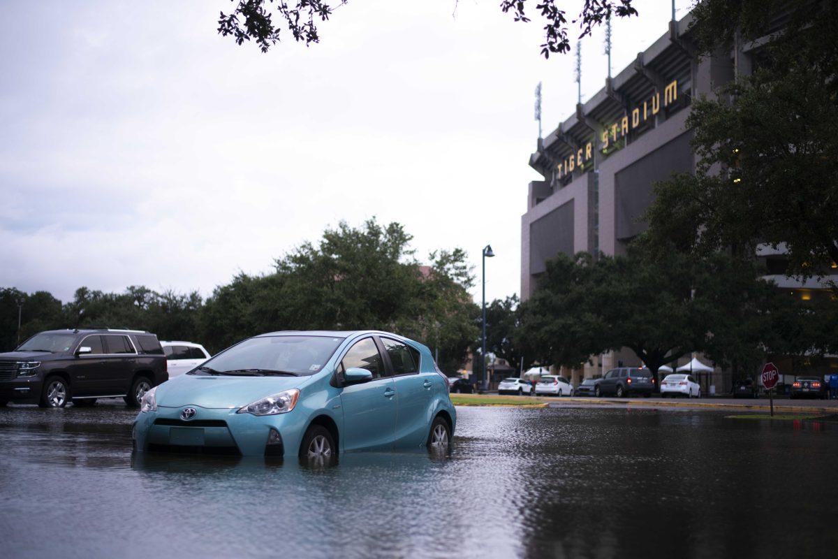 A Toyota sits flooded Wednesday, Sept. 15, 2021, during Tropical Depression Nicholas in the Tiger Stadium Lot on LSU's campus in Baton Rouge, La.