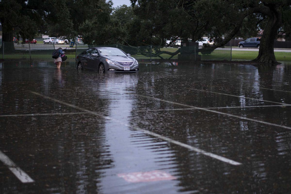 LSU student Megan Rodgers checks out her car Wednesday, Sept. 15, 2021, during Tropical Depression Nicholas in the Tiger Stadium parking lot on LSU's campus in Baton Rouge, La.