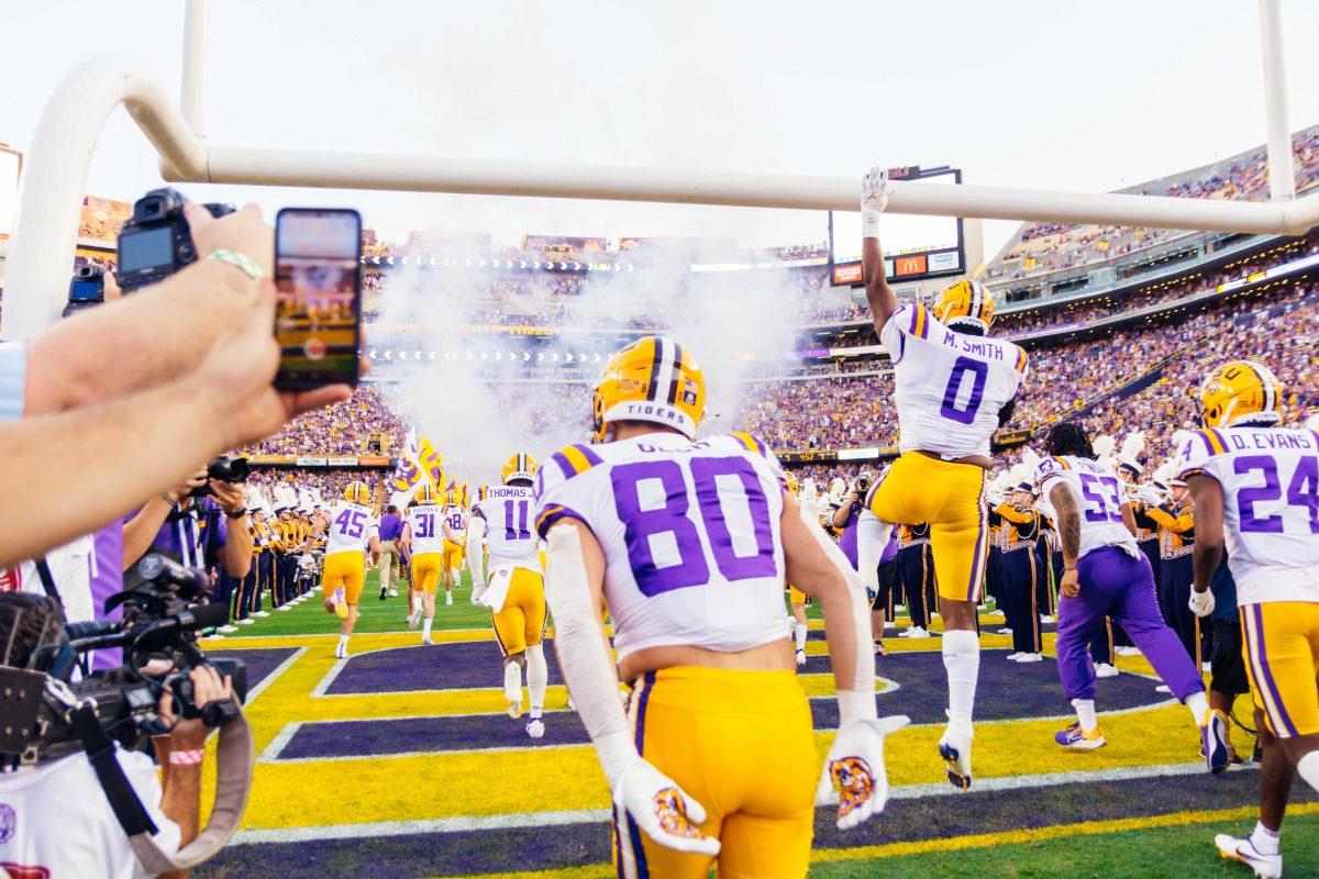 LSU football freshman wide receiver Jack Bech runs onto the field while freshman defensive lineman Maason Smith jumps and hits the field goal Saturday, Sept. 11, 2021, before LSU's 34-7 win against McNeese at Tiger Stadium in Baton Rouge, La.