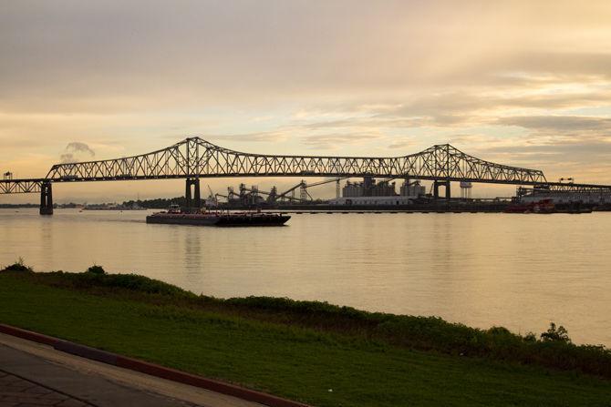 The Mississippi River runs through downtown Baton Rouge on the evening of Sunday, Sept. 23, 2018. The Horace Wilkinson bridge can be seen crossing the bridge in the distance.