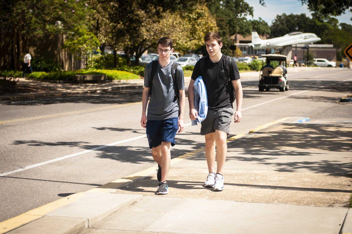 Animal science sophomore Kade Pigford (left) and civil engineering sophomore Alex Vidrine (right) walk on Wednesday, Sept. 22, 2021 on S. Stadium Drive on LSU's campus in Baton Rouge, La.