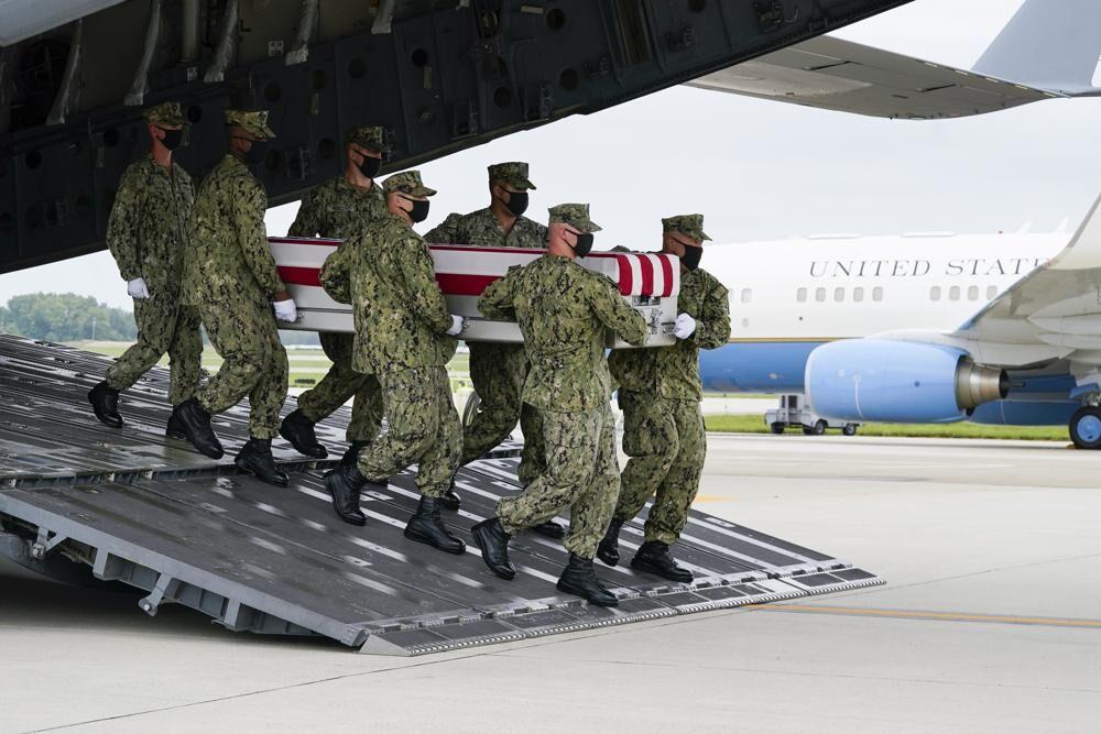 A Navy carry team moves a transfer case containing the remains of Navy Corpsman Maxton W. Soviak, 22, of Berlin Heights, Ohio, Sunday, Aug. 29, 2021, during a casualty return at Dover Air Force Base, Del. According to the Department of Defense, Soviak died in an attack at Afghanistan's Kabul airport, along with 12 other U.S. service members supporting Operation Freedom's Sentinel.