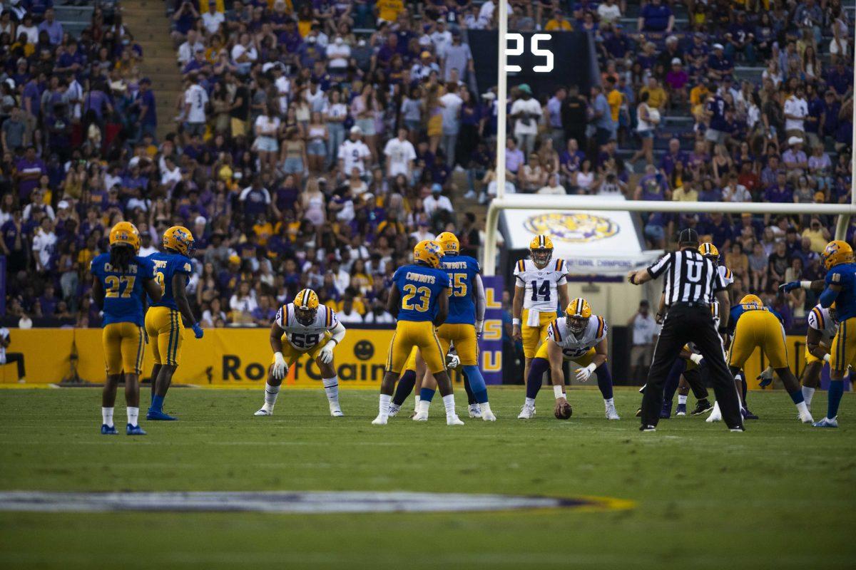 LSU football sophomore quarterback Max Johnson (14) waits to receive the ball from senior center Liam Shanahan (56) Saturday, Sept. 11, 2021, during LSU&#8217;s 34-7 win against McNeese State University at Tiger Stadium in Baton Rouge, La.