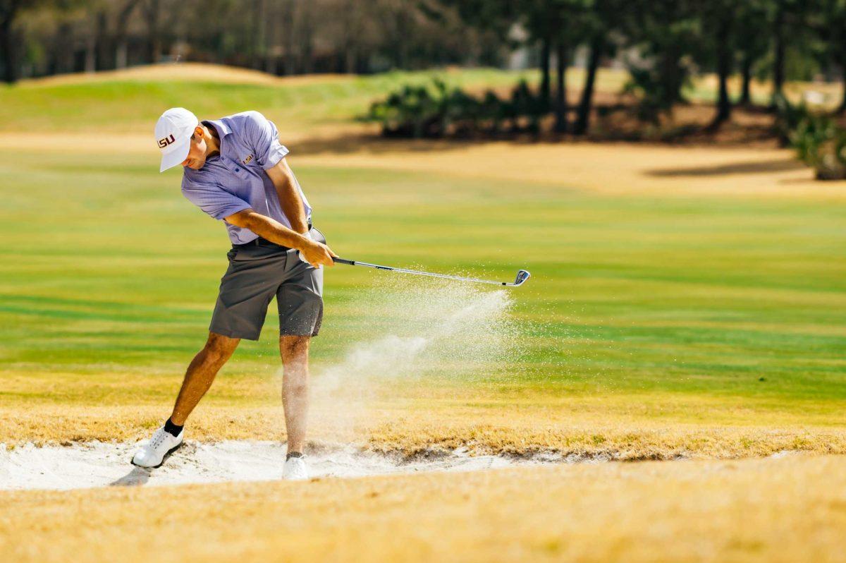 LSU men's golf sophomore Connor Gaunt hits the ball out of the bunker Friday, Feb. 26, 2021 during the LSU Invitational hosted at the University Club on Memorial Tower Drive in Baton Rouge, La.