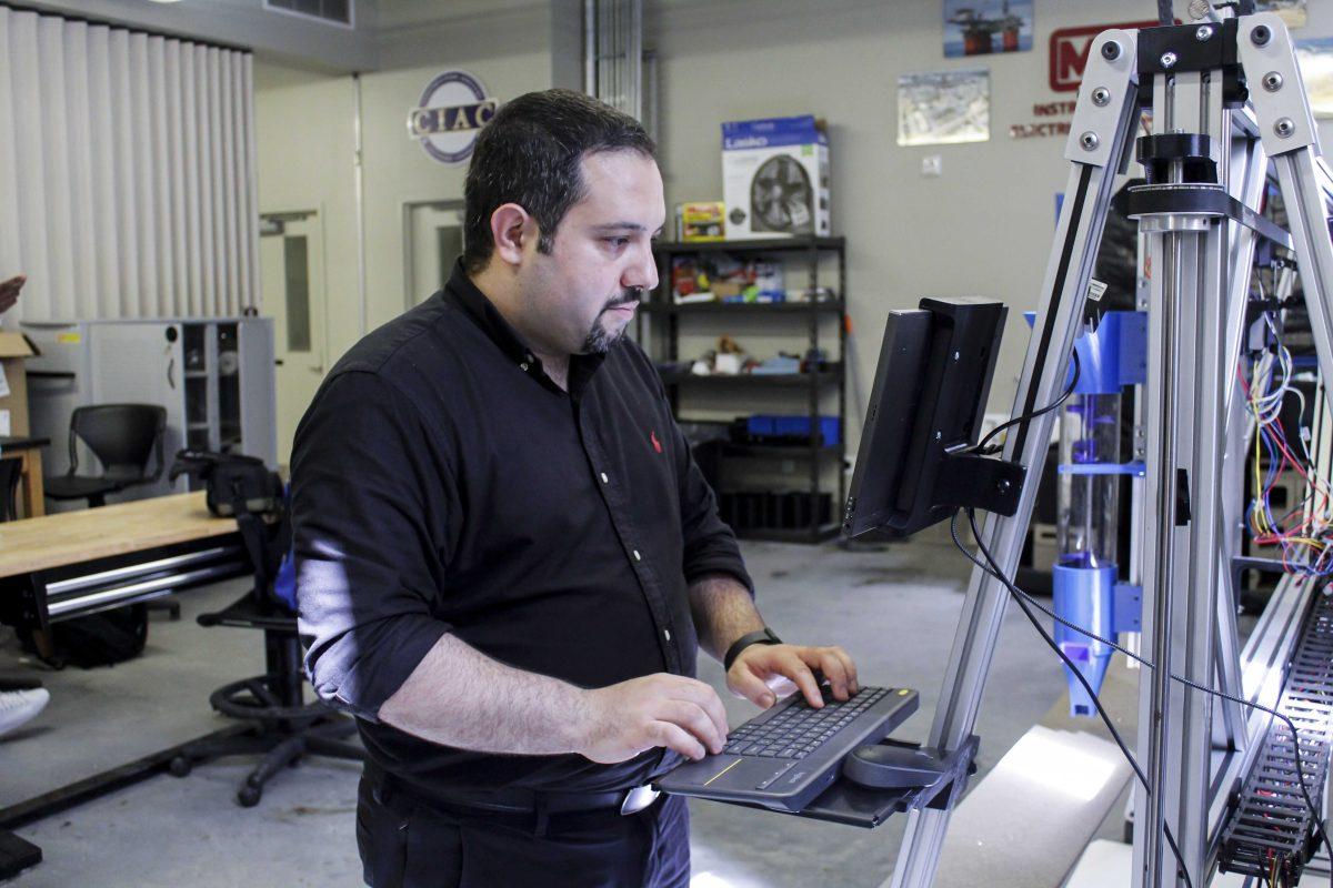 LSU professor Ali Kazemian loads files for the 3D printer inside a lab building near Patrick F. Taylor Hall on Wednesday, September 16, 2021, on South Quad Drive, in Baton Rouge, La.