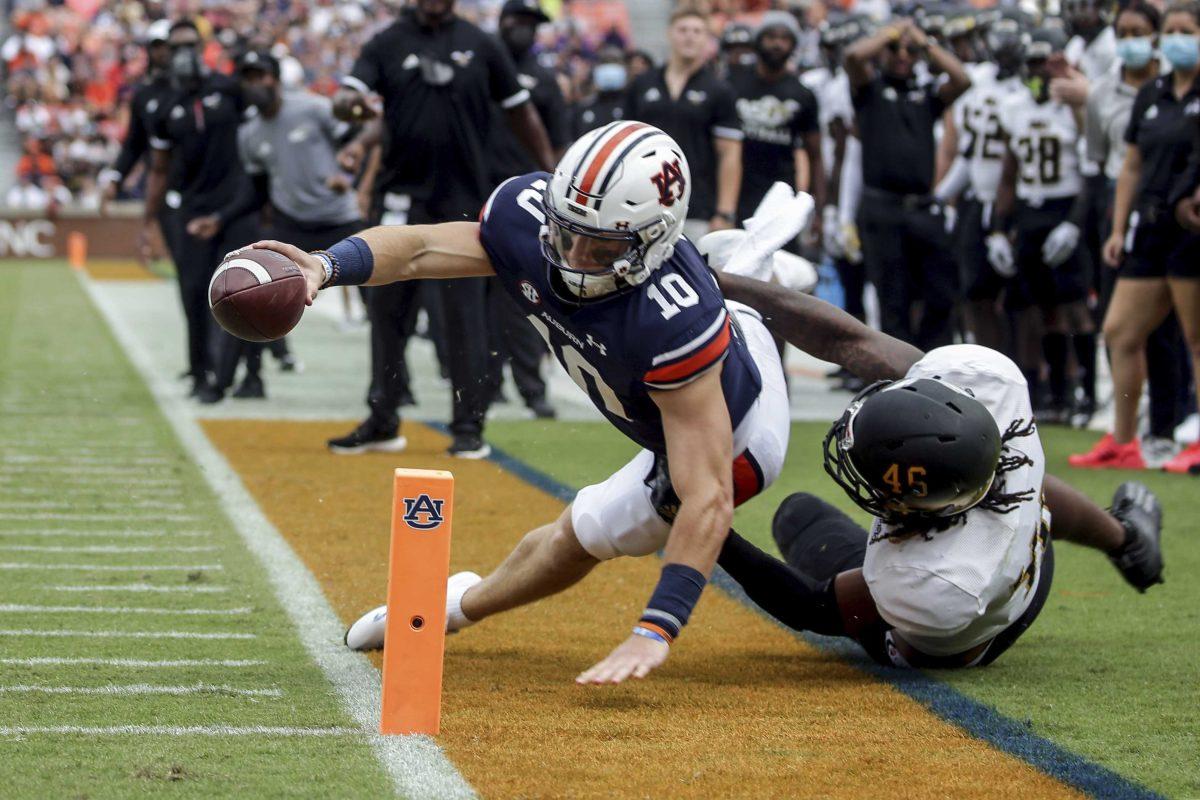 Auburn quarterback Bo Nix (10) comes up short as he stretches for the goal line as Alabama State linebacker Jake Howard (46) tackles him during the first half of an NCAA football game Saturday, Sept. 11, 2021, in Auburn, Ala. (AP Photo/Butch Dill)