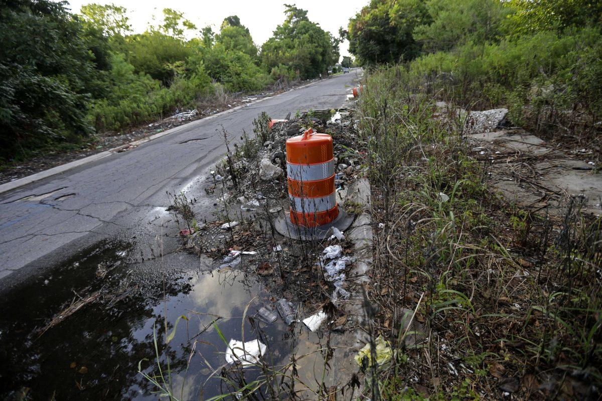 Debris lies in the street on an abandoned block in a residential section of New Orleans East, Thursday, Aug. 6, 2015. A decade ago, polluted water up to 20 feet deep flooded 80 percent of the city. Katrina killed more than 1,500 people in Louisiana, many of them drowning inside their homes, and hundreds more simply disappeared, the National Hurricane Center reported a year later. (AP Photo/Gerald Herbert)