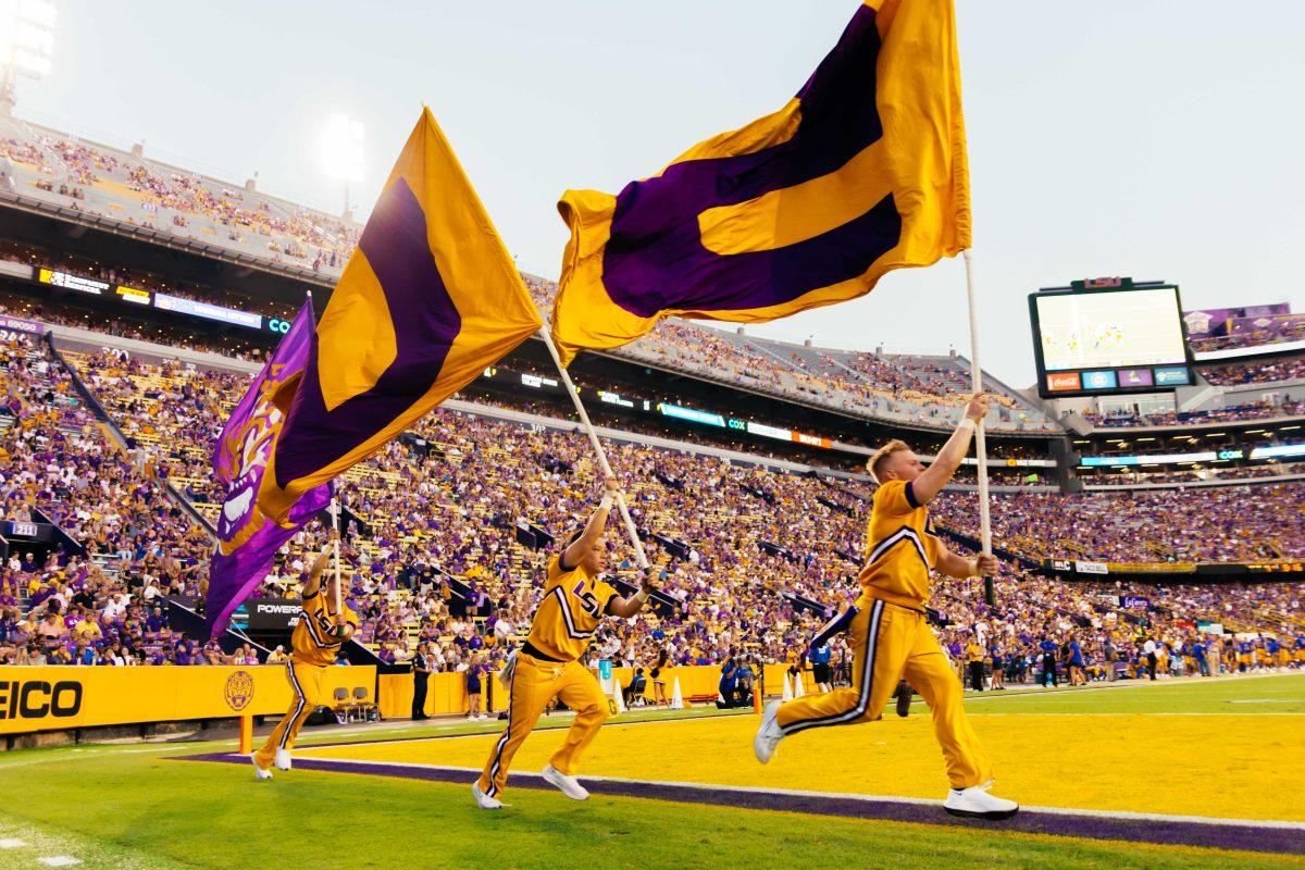 LSU cheerleaders run with flags up and down the endzone Saturday, Sept. 11, 2021, during LSU's 34-7 win against McNeese at Tiger Stadium in Baton Rouge, La.