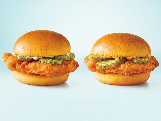 Two Sonic chicken slinger sandwiches sit ready for your consumption.