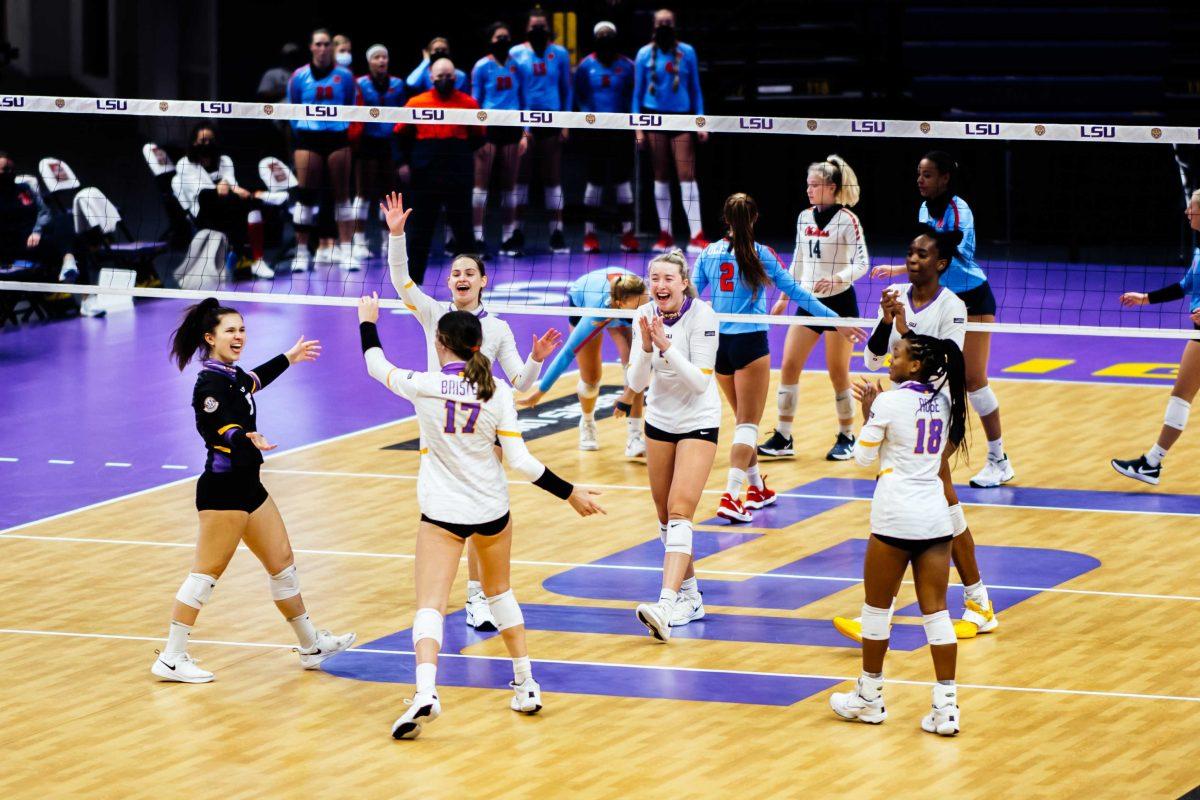 LSU volleyball team celebrates after they score the first point in the first set of the game Sunday, Feb. 28, 2021 during LSU's 2-3 loss against Ole Miss in the Pete Maravich Assembly Center on N. Stadium Drive in Baton Rouge, La.