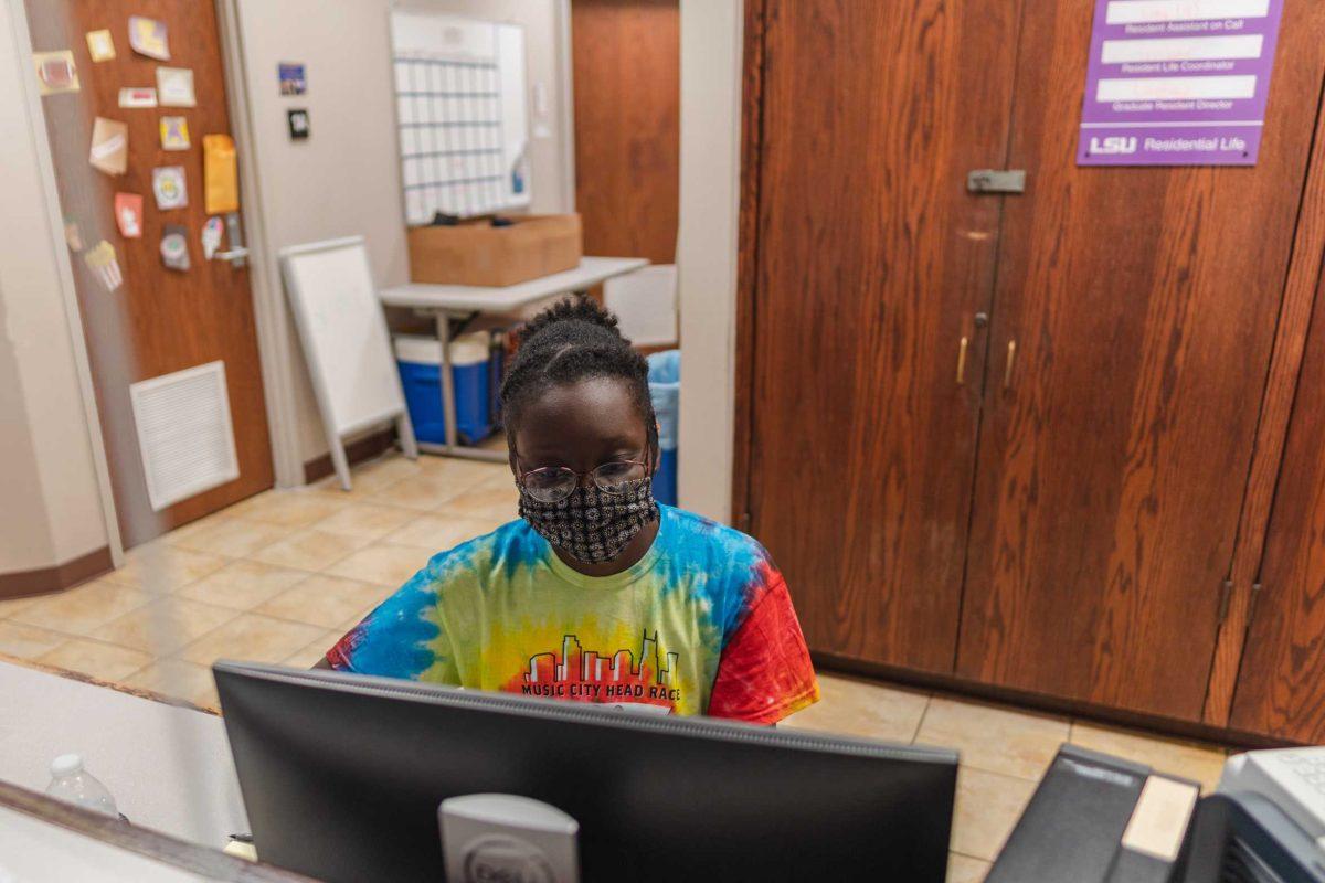 Animal sciences sophomore Lavita Washington works on the computer on Tuesday, Oct. 26, 2021, at the front desk of the East Campus Apartments on Campus Lake Road in Baton Rouge, La.