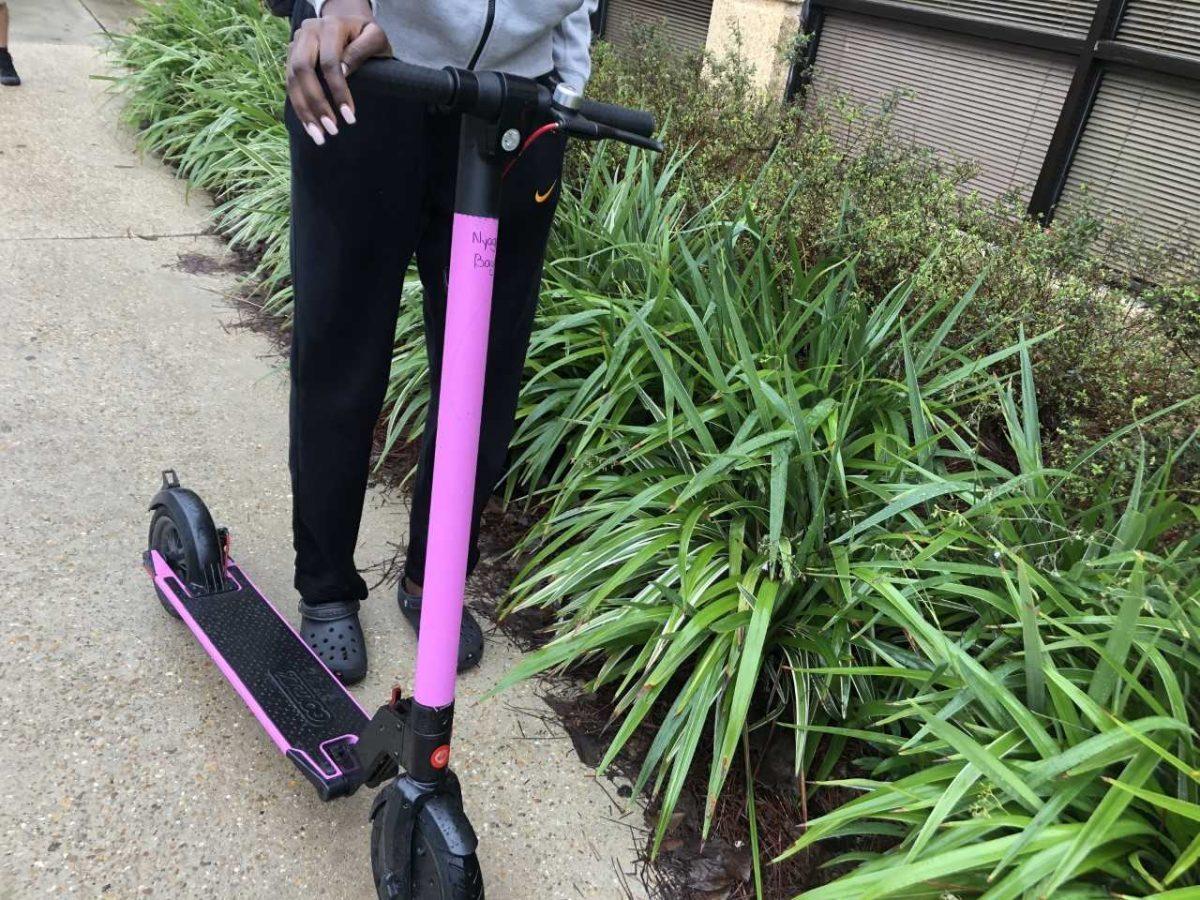 An LSU student athlete uses an electric scooter to navigate campus on Tuesday, Oct. 15, 2019.