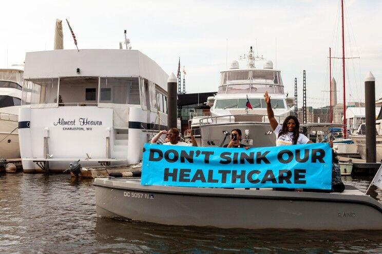 West Virginians protest at Senator Joe Manchin's houseboat, Almost Heaven, in the Washington marina.
