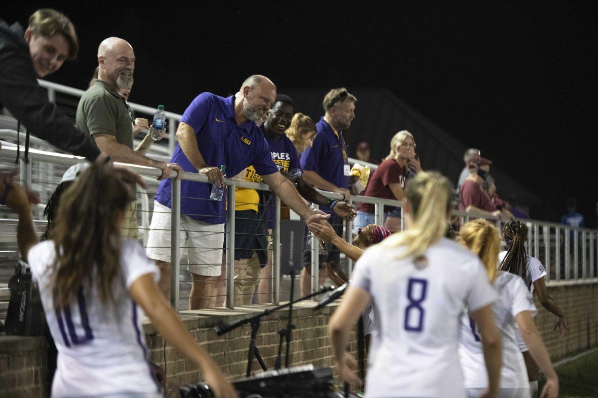 LSU fans smile as the LSU soccer team gives high fives Thursday, Oct. 21, 2021 after LSU&#8217;s 4-0 win against South Carolina at the LSU Soccer Stadium in Baton Rouge, La.