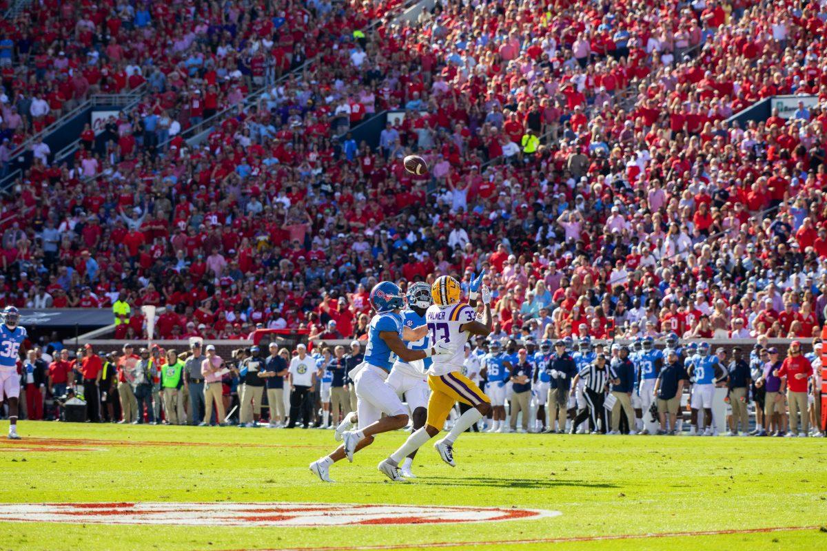 LSU football junior wide receiver Trey Palmer (33) catches a long pass over two University of Mississippi defenders on Saturday, Oct. 23, 2021, during LSU's 31-17 loss against the University of Mississippi, in Vaught-Hemingway Stadium, Oxford, Mississippi.