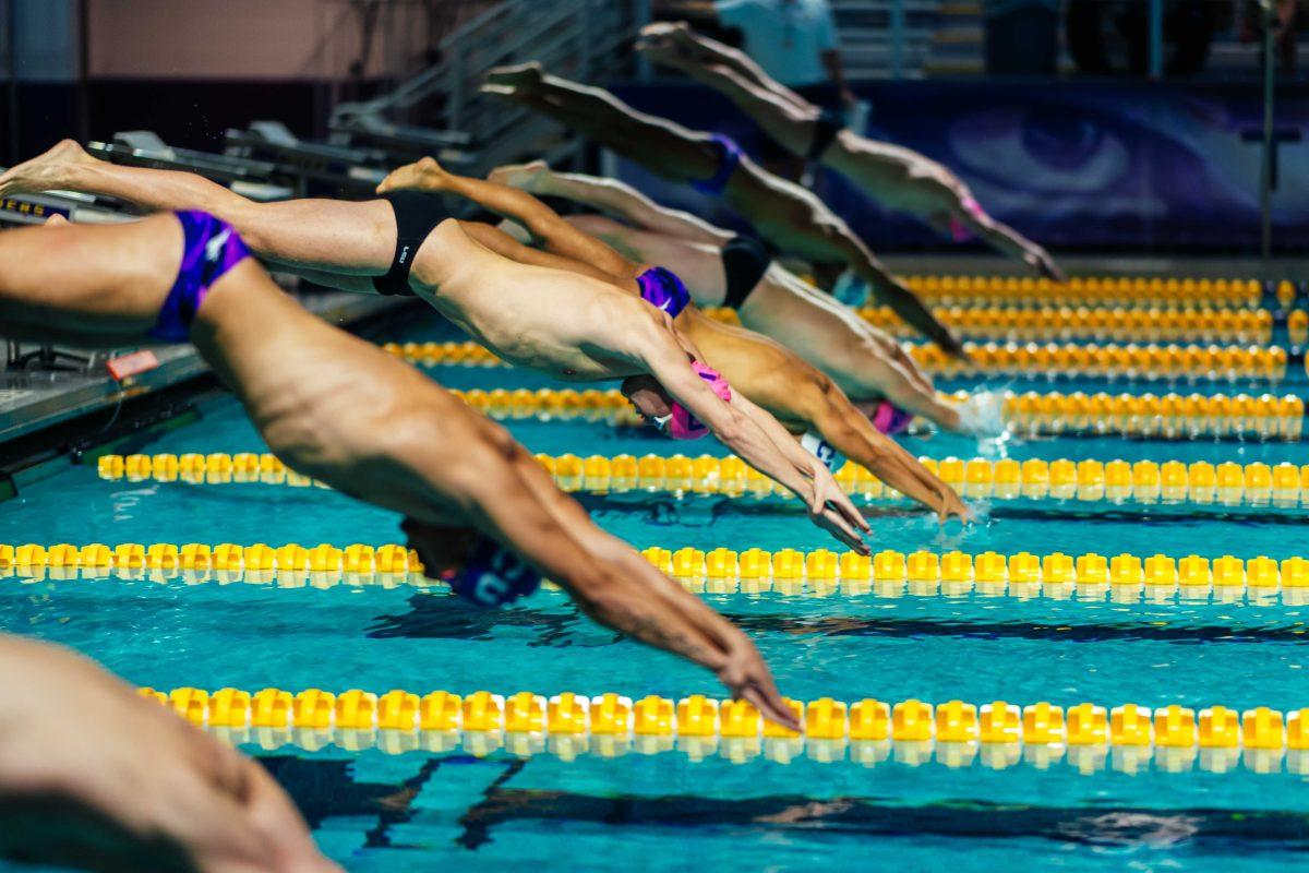 The LSU and GCU teams dive in Saturday, Oct. 9, 2021, during LSU men's 194-106 win over GCU at the LSU Natatorium in Baton Rouge, La.